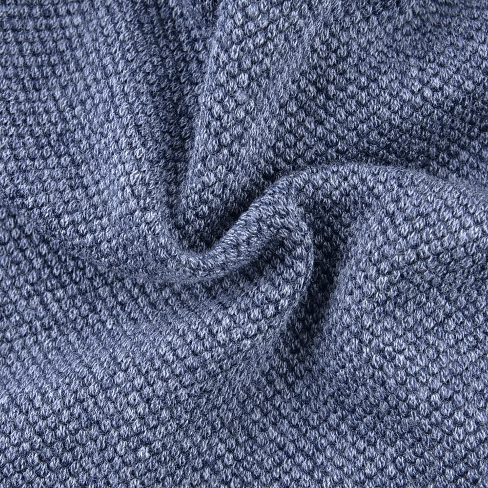 Close-up of a textured solid blue knit fabric for a unisex beanie, showcasing detailed stitching and soft material.